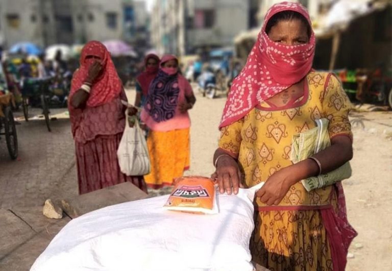 Woman Receiving Grain Kits